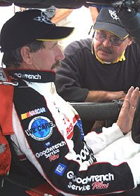 Picture of Dale in the Corvette C5-R racecar discussing strategy.